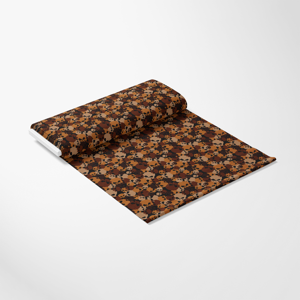 A rolled-out piece of fabric with a brown, black, and orange geometric pattern on a white background.