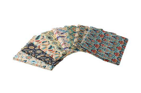 A stack of folded fabric squares featuring various colorful patterns, including paisley and floral designs, arranged in a fan-like display.