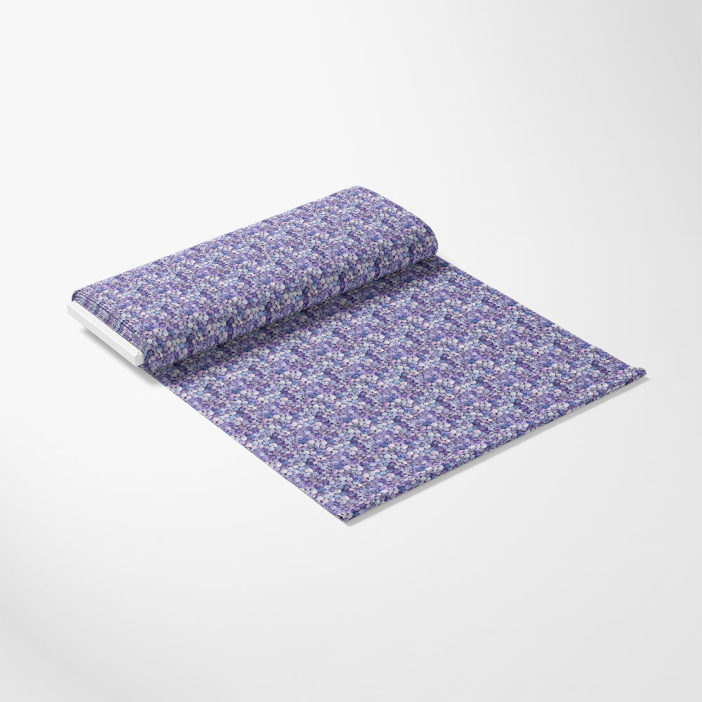 A roll of wallpaper featuring a purple and white floral pattern is partially unrolled on a plain surface.