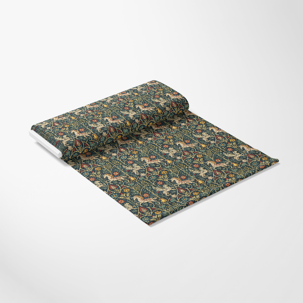 A roll of dark-colored patterned fabric partially unrolled on a white surface, displaying an intricate floral and bird design in shades of green, yellow, red, and beige.
