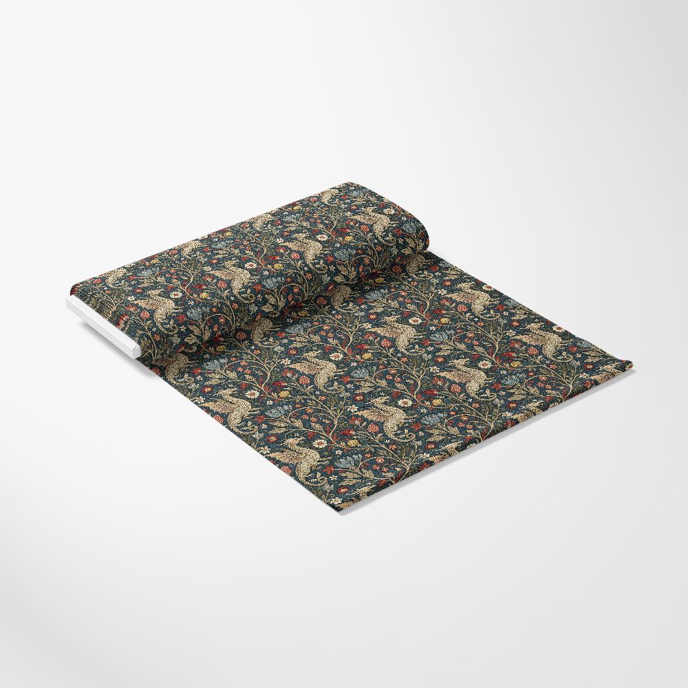 A roll of fabric partially unrolled on a white background, featuring an intricate floral and vine pattern in dark green, red, beige, and gold tones.