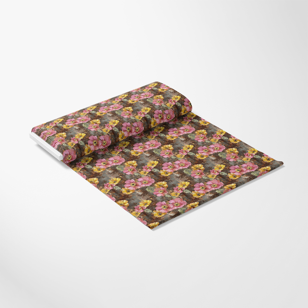 A roll of wallpaper features a floral pattern with pink and yellow flowers on a dark background, unrolled slightly on a white surface.