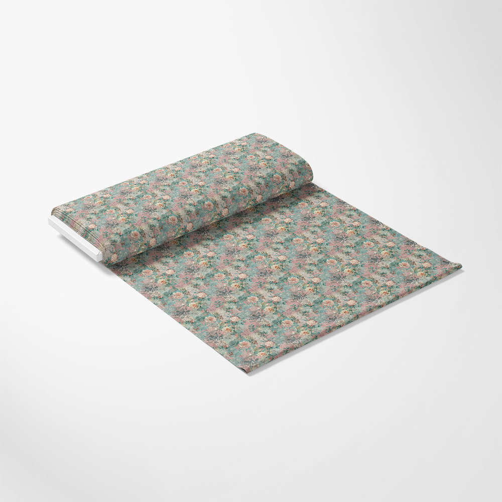 A roll of wallpaper partially unrolled on a white surface, featuring a floral pattern with pink and green hues.