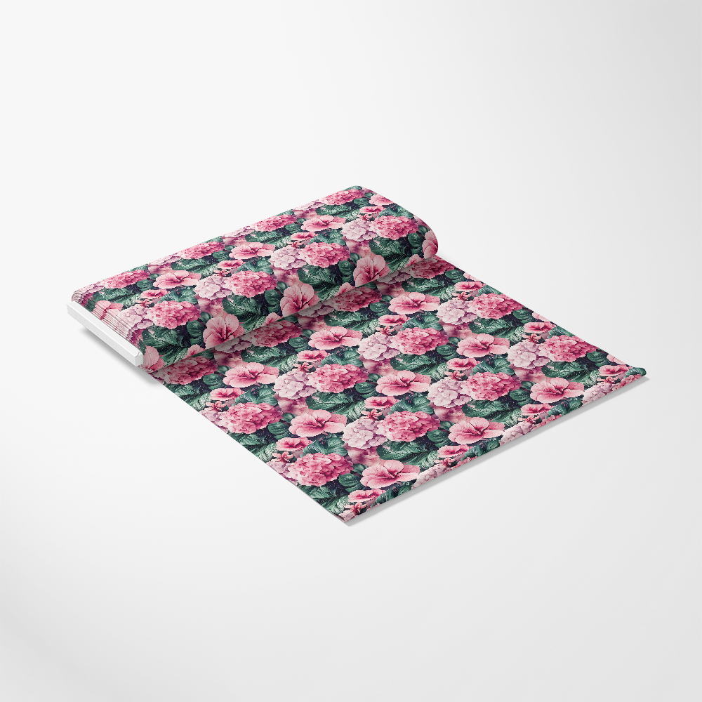 A roll of patterned fabric with pink flowers and green leaves on a white background, unrolled slightly to display the design.
