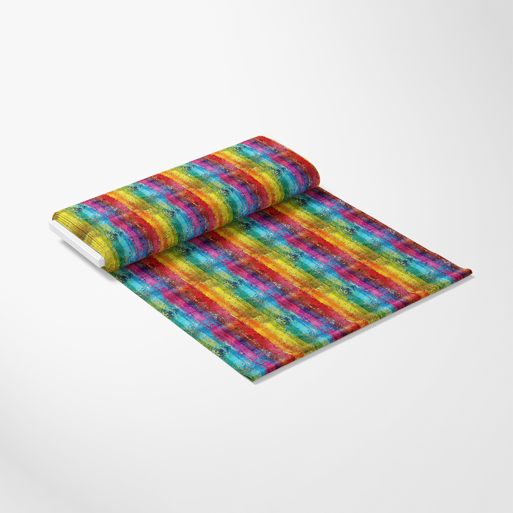 A roll of fabric partially unrolled on a white surface, displaying a colorful, striped pattern with a textured, watercolor-like appearance in red, yellow, green, blue, and purple.