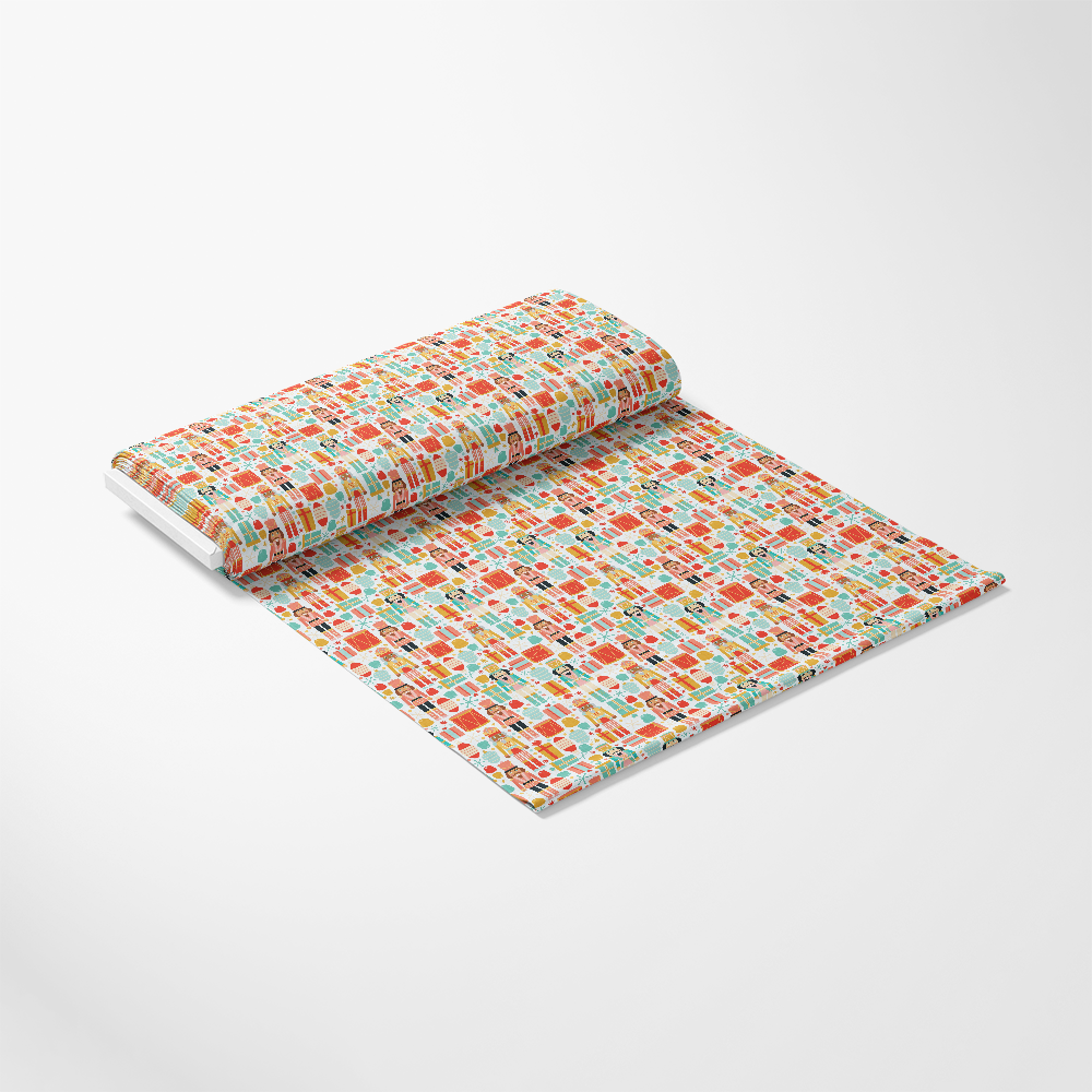 A roll of patterned fabric featuring colorful geometric shapes is partially unrolled on a plain white background.