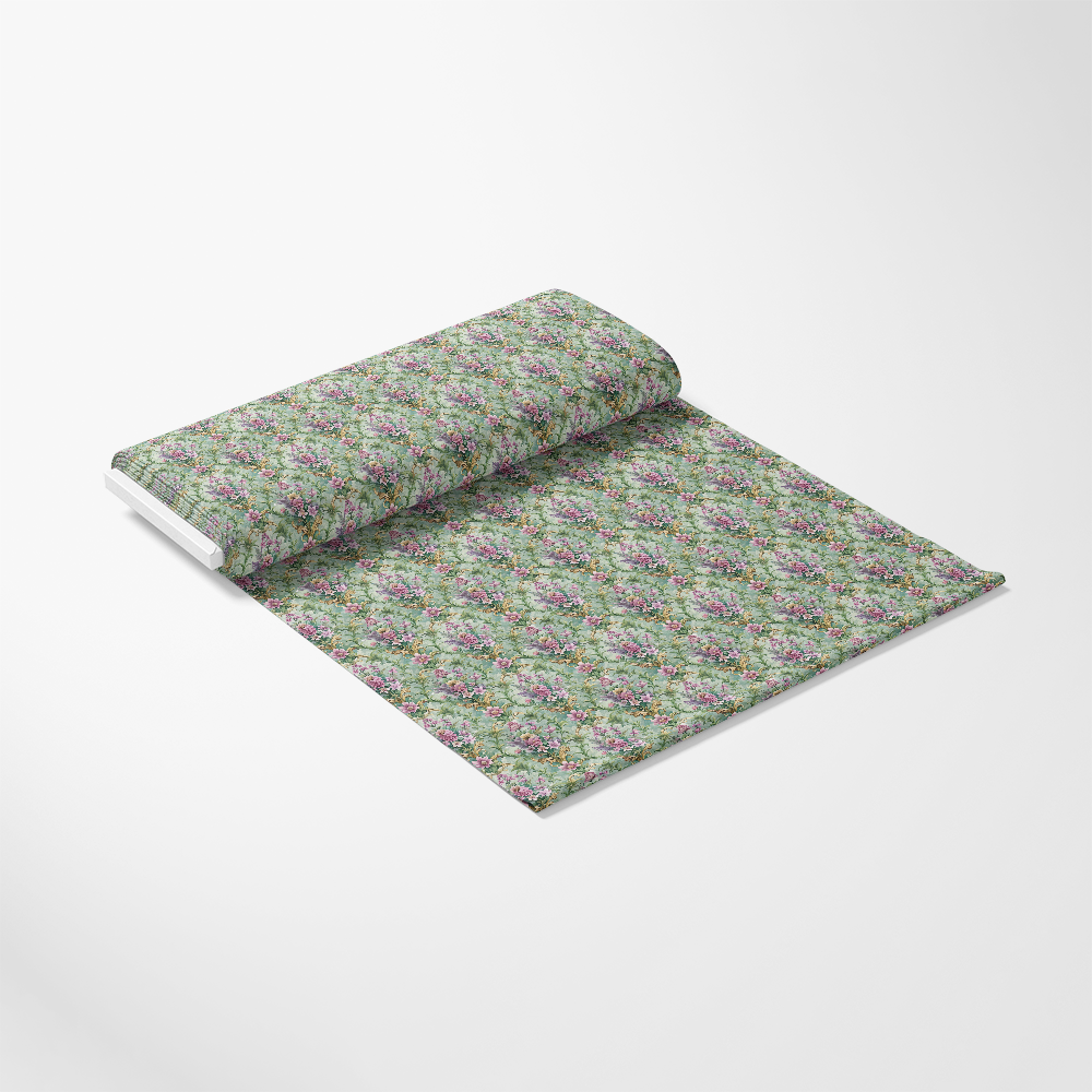A roll of wallpaper partially unrolled on a white surface, featuring a green background with a repeating floral pattern in pink, purple, and green tones.