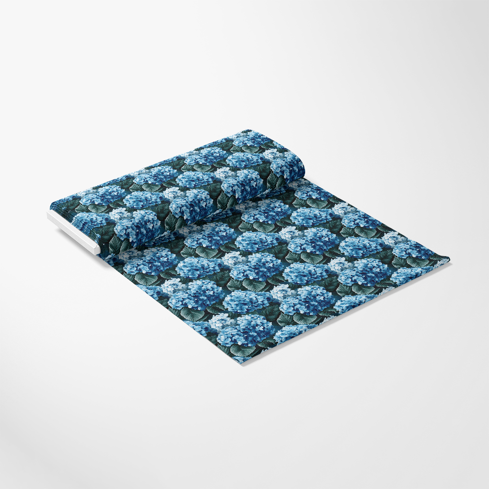 A roll of wallpaper featuring a blue hydrangea pattern on a white background.