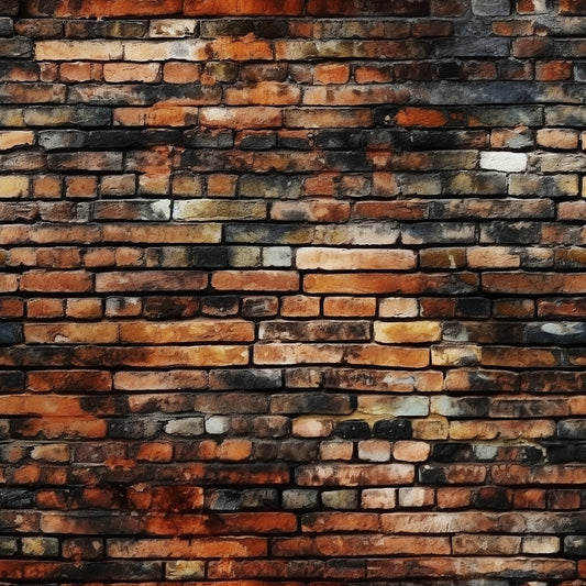 A wall made of variously colored bricks, featuring shades of red, orange, brown, and black, with a rough and uneven texture.