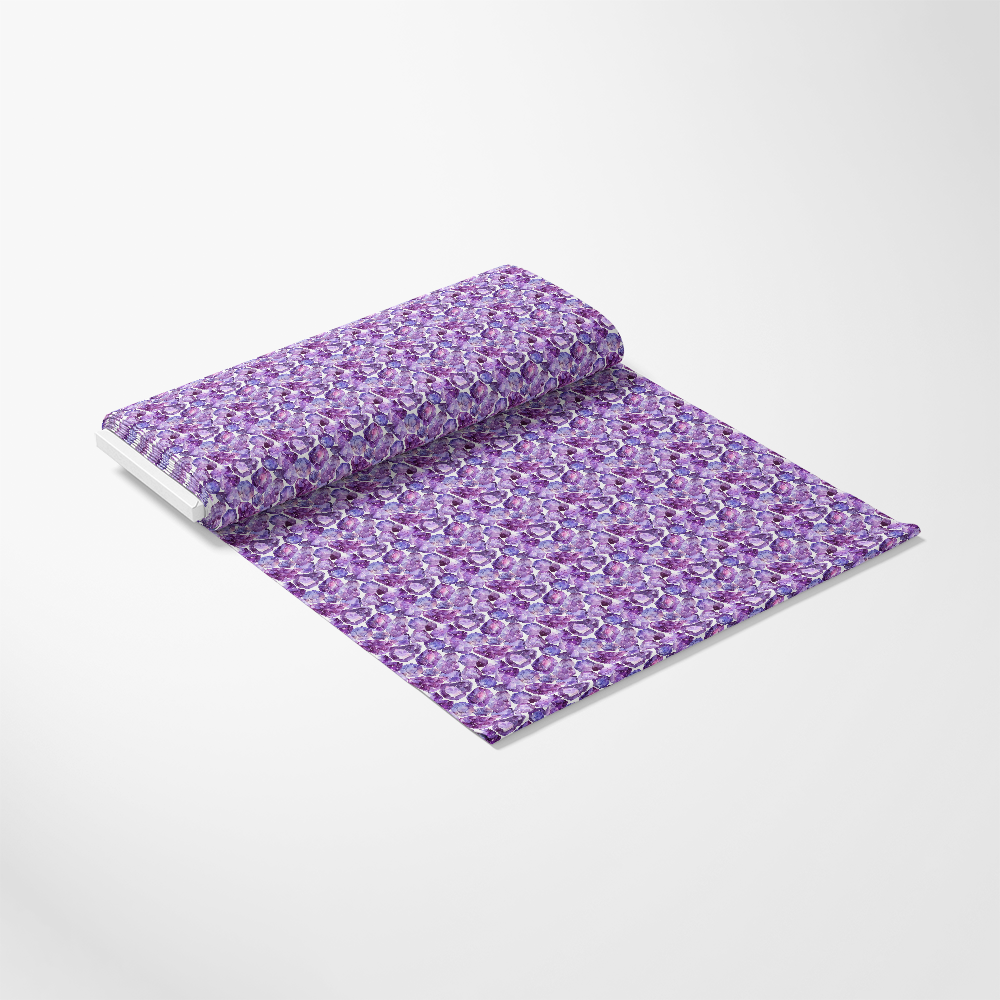 A notebook with a purple floral pattern cover lies open on a flat surface, displaying two pages.