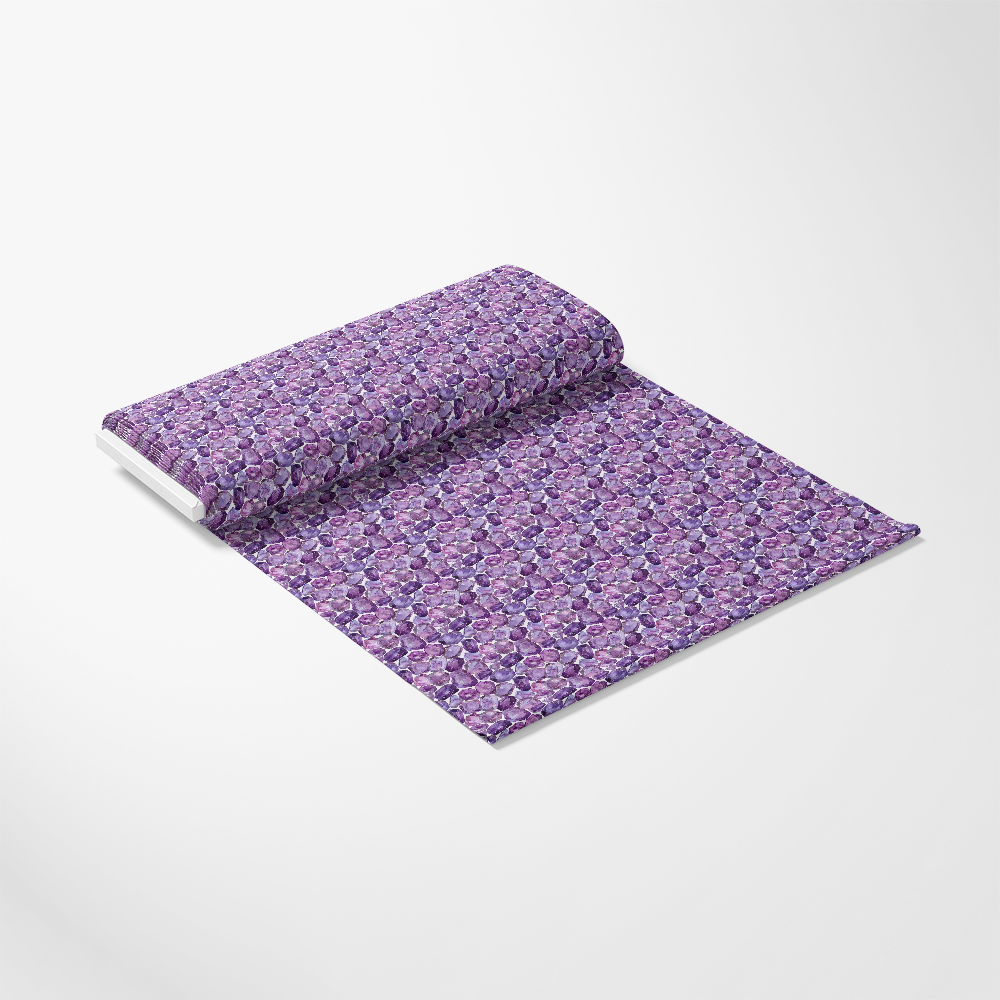 A roll of decorative wrapping paper with a vibrant purple floral pattern on a white background, partially unrolled.