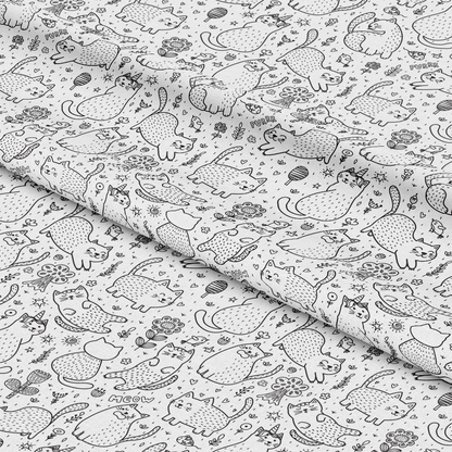 A fabric featuring a black and white pattern of various cartoon cats and small decorative elements like flowers and stars, displayed with slight folds.