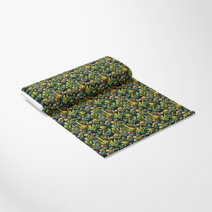 A roll of fabric with a colorful botanical pattern featuring various plants and fruits on a white background.