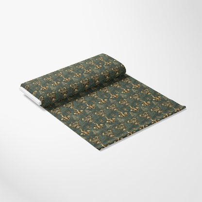 A rolled out section of green wallpaper with a repeating decorative pattern featuring floral motifs, displayed on a plain white background.