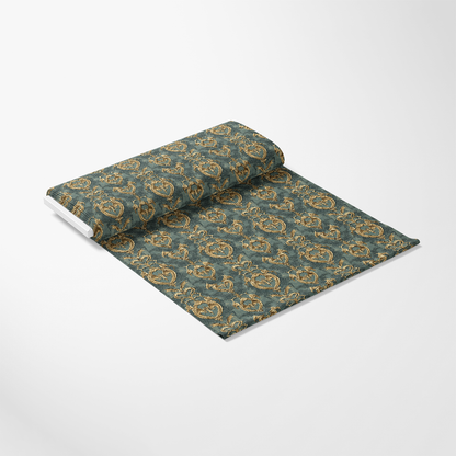 A textured wallpaper roll partially unfurled, displaying a repeated gold floral pattern on a green background.