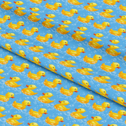 Blue fabric with a repeated pattern of yellow rubber ducks and bubbles.