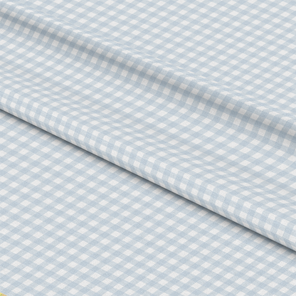 A piece of fabric with a light blue and white gingham checkered pattern, shown with a visible fold running diagonally across the image.