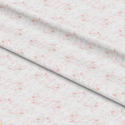 A close-up view of light-colored fabric with a subtle, textured pattern in soft red, featuring diagonal folds across the material.