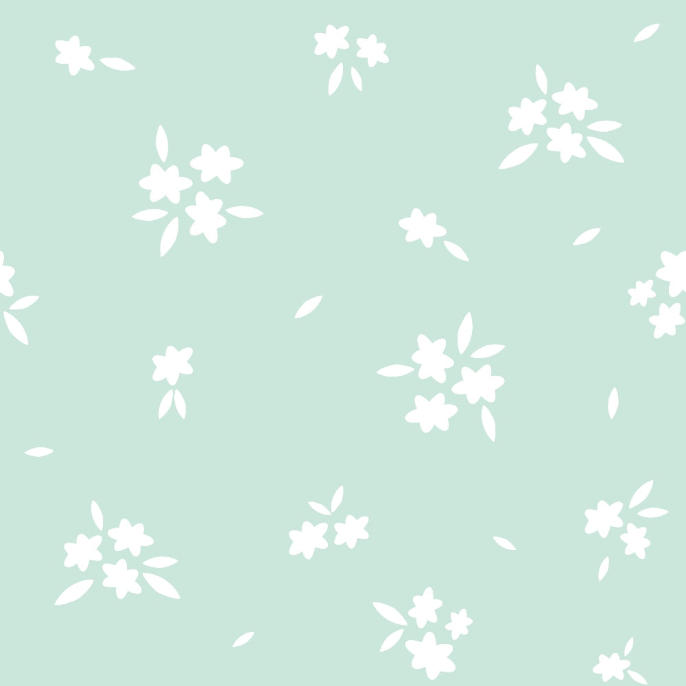 A pastel green background with white floral patterns scattered across.