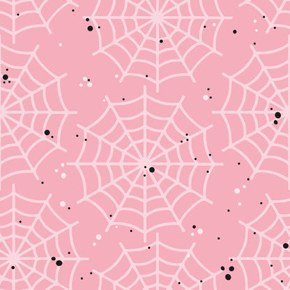 Pink background with a pattern of white spider webs and scattered black dots.