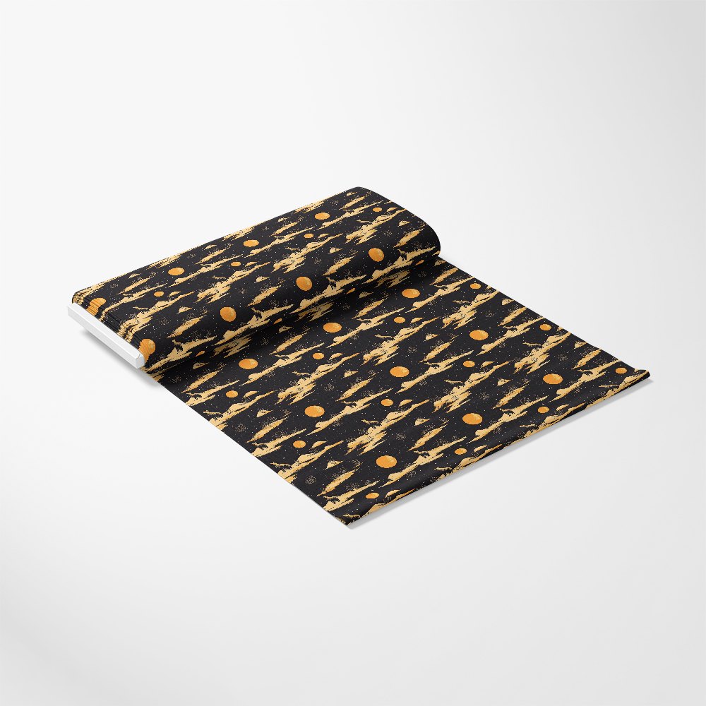A rolled-out section of fabric featuring a black background with an abstract pattern of orange planets and rocket ships.