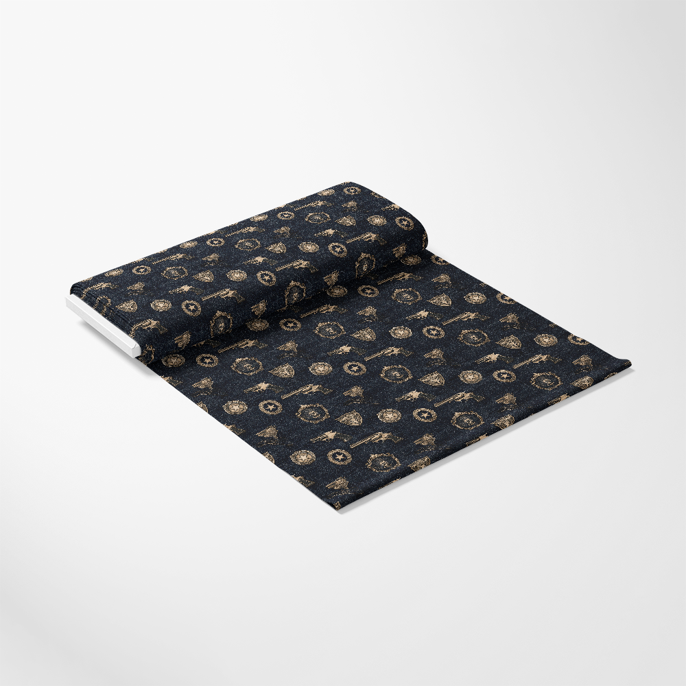 A partially unrolled dark fabric with a gold geometric pattern on a plain white background.