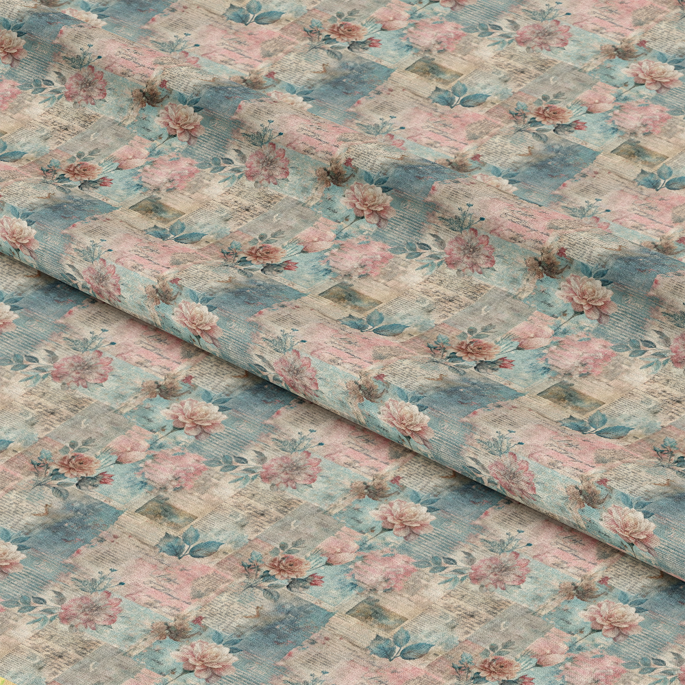A close-up of fabric featuring a checkered pattern with faded blue, beige, and pink tones, decorated with clusters of pink and peach flowers and green leaves. The fabric is slightly folded.