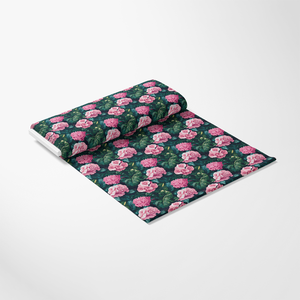 Rolled fabric with a floral print, featuring pink roses and green leaves on a dark background.