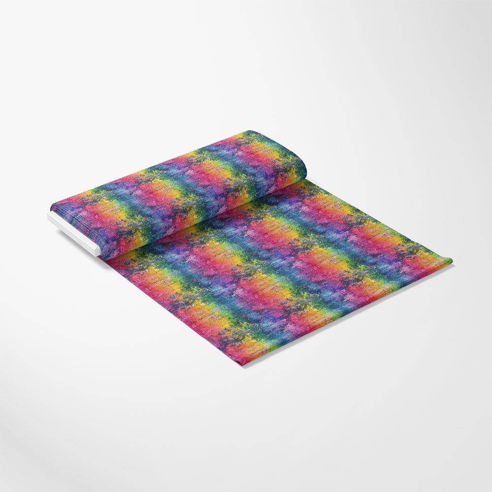 A roll of fabric partially unrolled, featuring a colorful tie-dye pattern with red, blue, yellow, and green hues on a white background.