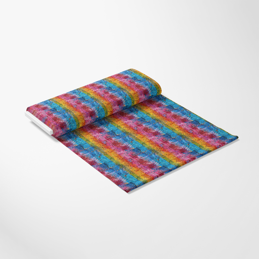 A rolled-out sheet of fabric with a vibrant, multicolored striped pattern featuring red, blue, yellow, green, and purple tones, displayed on a plain white background.