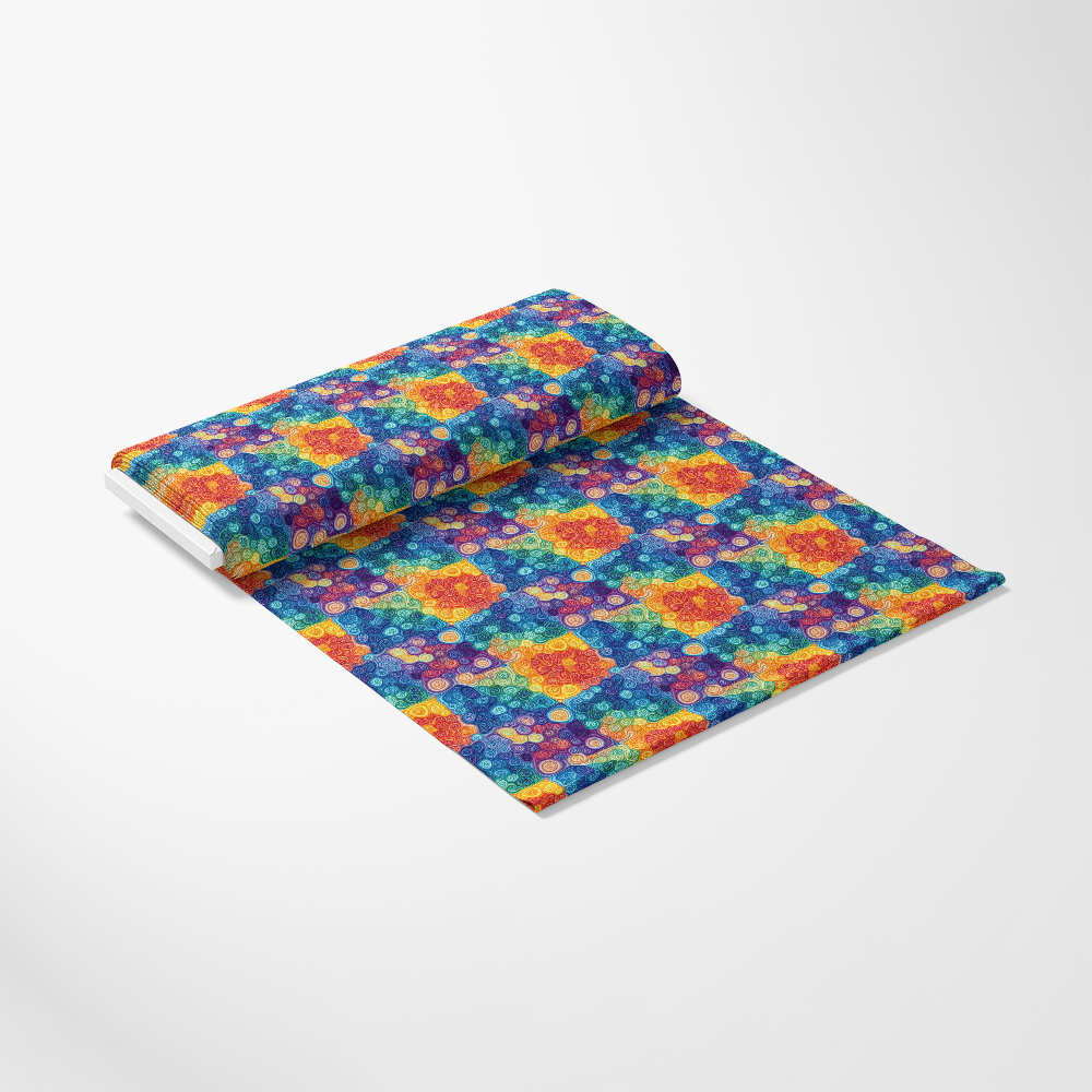 Roll of colorful fabric featuring a geometric pattern with overlapping circles and squares in vibrant red, blue, yellow, green, and orange on a white background.