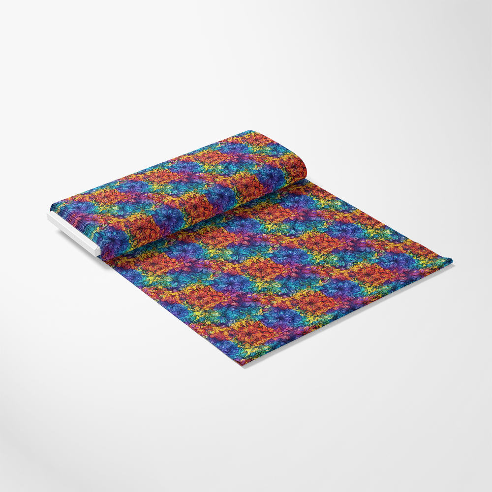 Roll of fabric with a vibrant, multicolored tie-dye pattern on a white background.