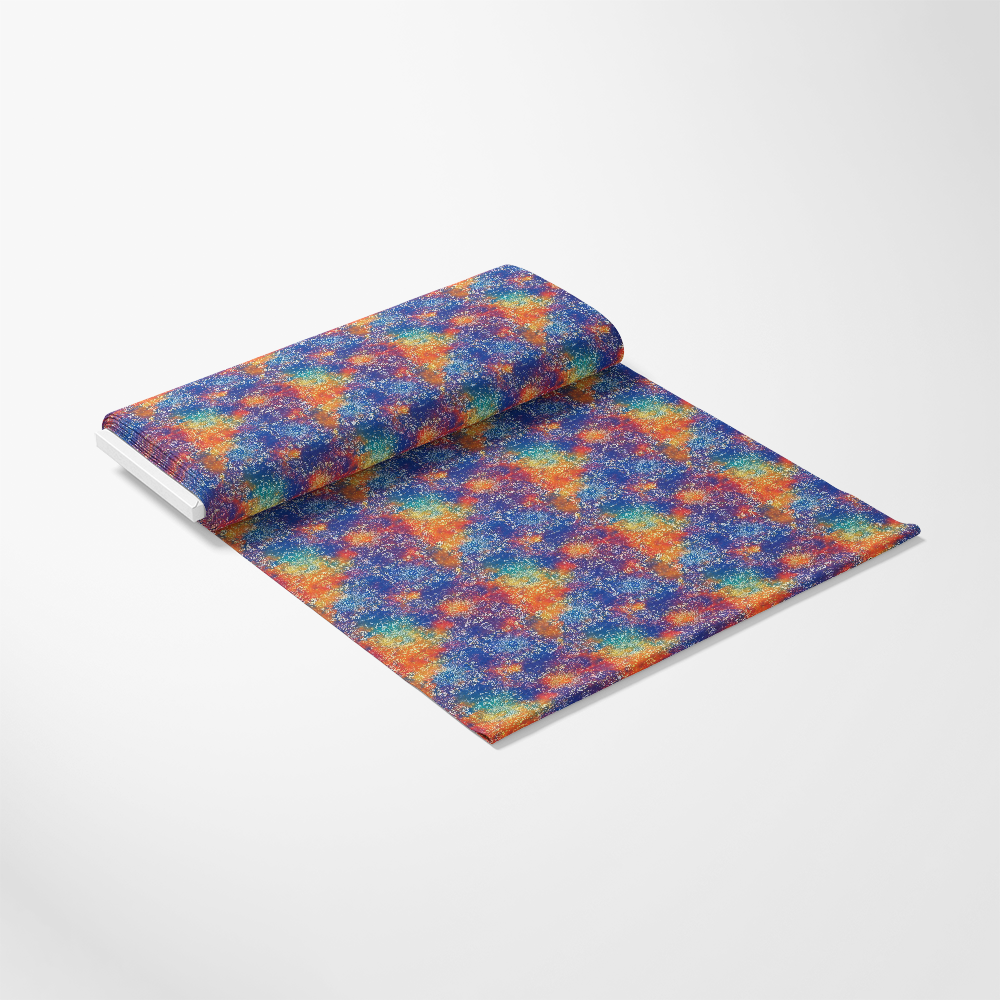 A roll of fabric with a colorful geometric pattern featuring overlapping triangles in blue, orange, and yellow hues, partially unrolled on a white surface.