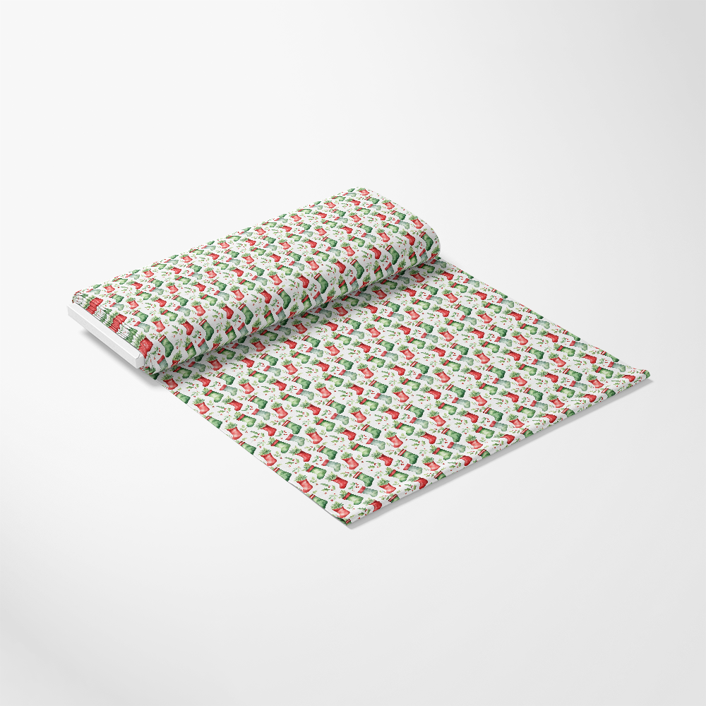 A roll of wrapping paper featuring a repeating pattern of red and green Santa Claus illustrations on a white background.