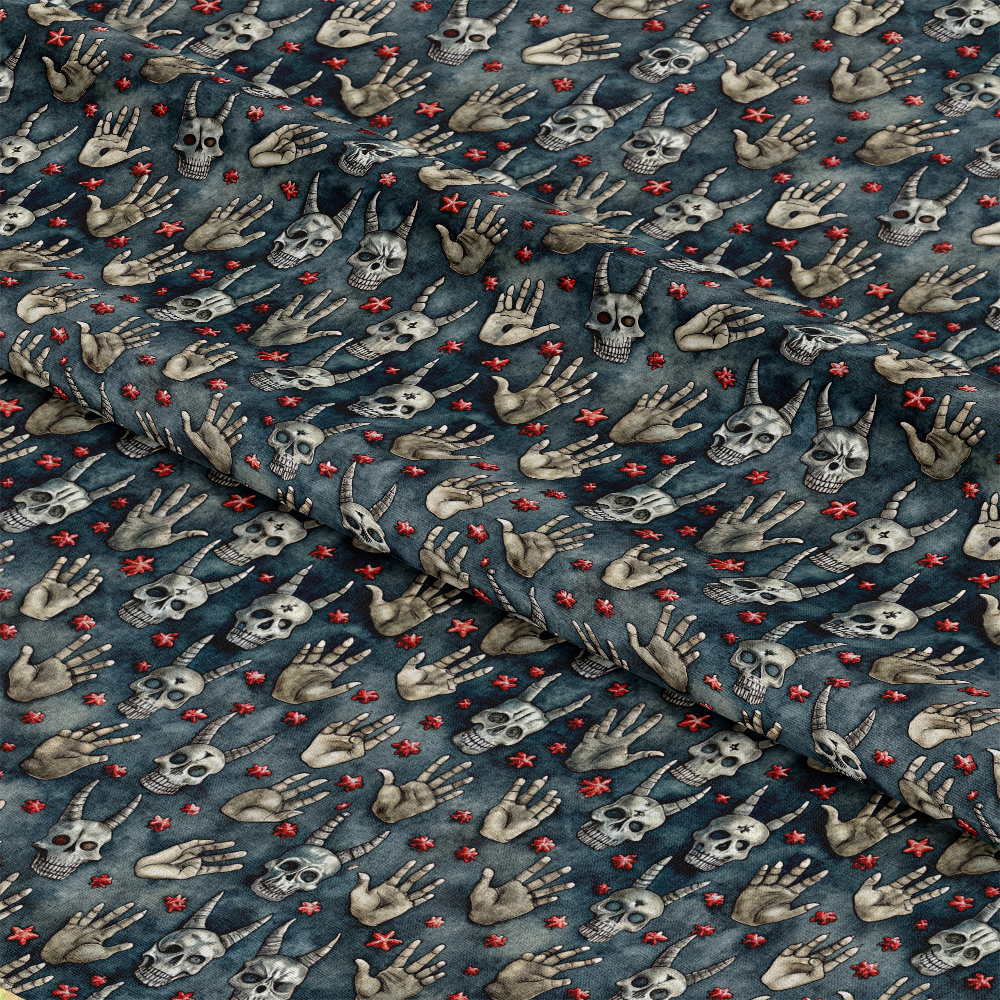 A piece of dark blue fabric featuring a repeating pattern of skulls, skeletal hands in various gestures, and small red star-like symbols. The fabric is slightly wrinkled and folded.