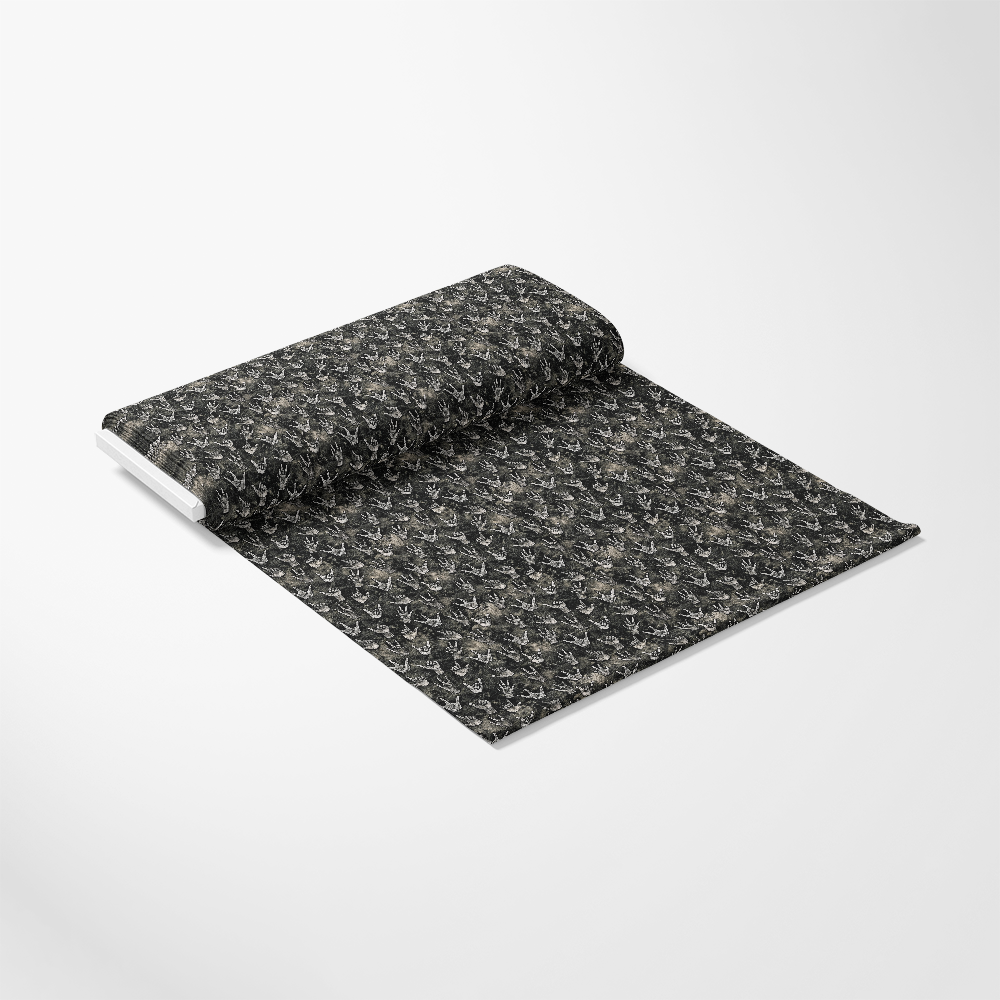 A roll of black wallpaper with a subtle, intricate gray and beige pattern is partially unrolled on a white background. The wallpaper is shown at an angle, displaying its texture and design.