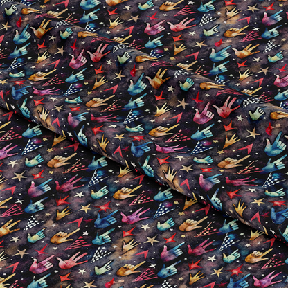 A patterned fabric features colorful illustrations of hands making the rock on gesture, stars, and lightning bolts on a dark background. The fabric is slightly folded, showing a repeating design.