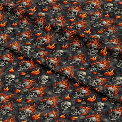 A patterned fabric features repeated illustrations of skulls, some surrounded by orange flames, set against a dark, smoky background. The fabric is shown with light folds and shadows.