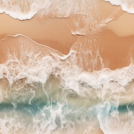 Aerial view of ocean waves meeting a sandy beach, with white foam creating patterns along the shore.