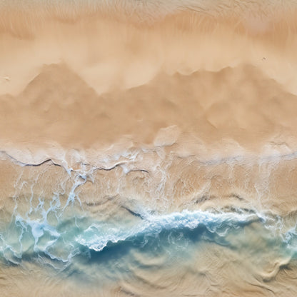 Aerial view of ocean waves gently crashing onto a sandy beach, creating white foam patterns.