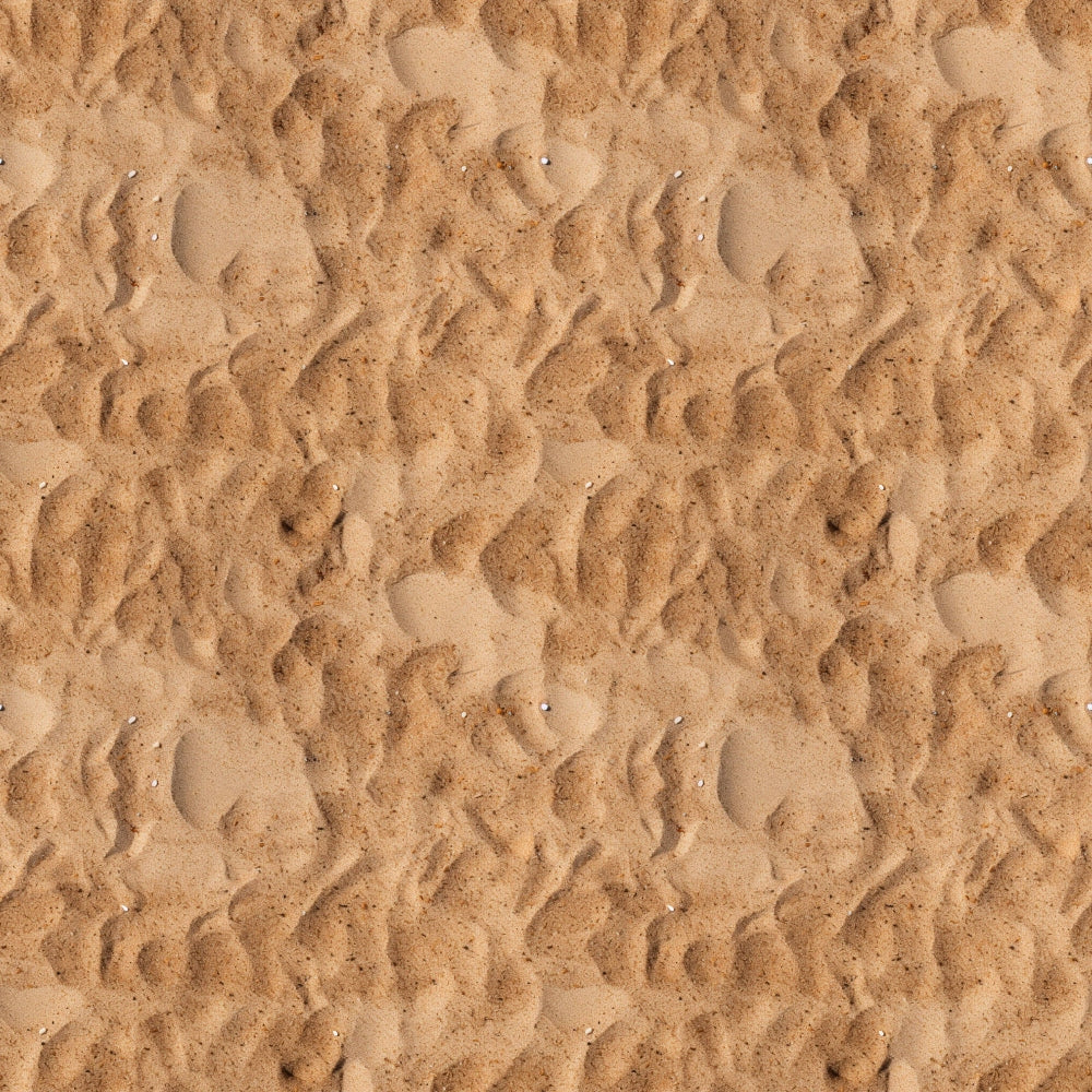 Close-up view of textured sand with ripples and small impressions, creating a wavy pattern across the surface.