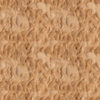 Close-up view of textured sand with ripples and small impressions, creating a wavy pattern across the surface.