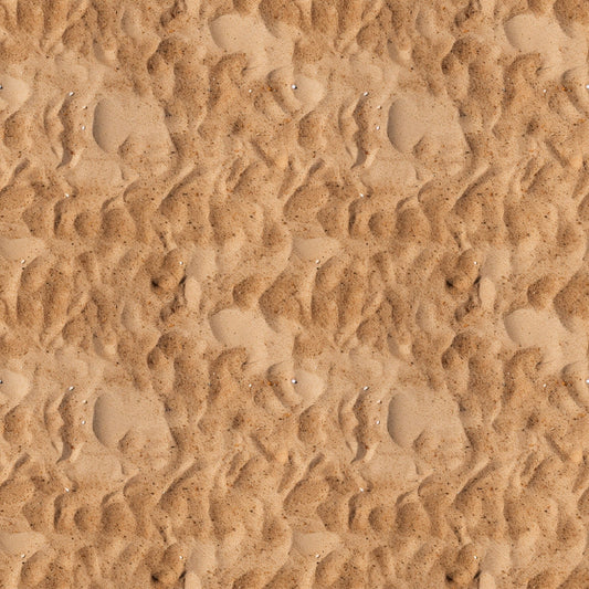 Close-up view of textured sand with ripples and small impressions, creating a wavy pattern across the surface.