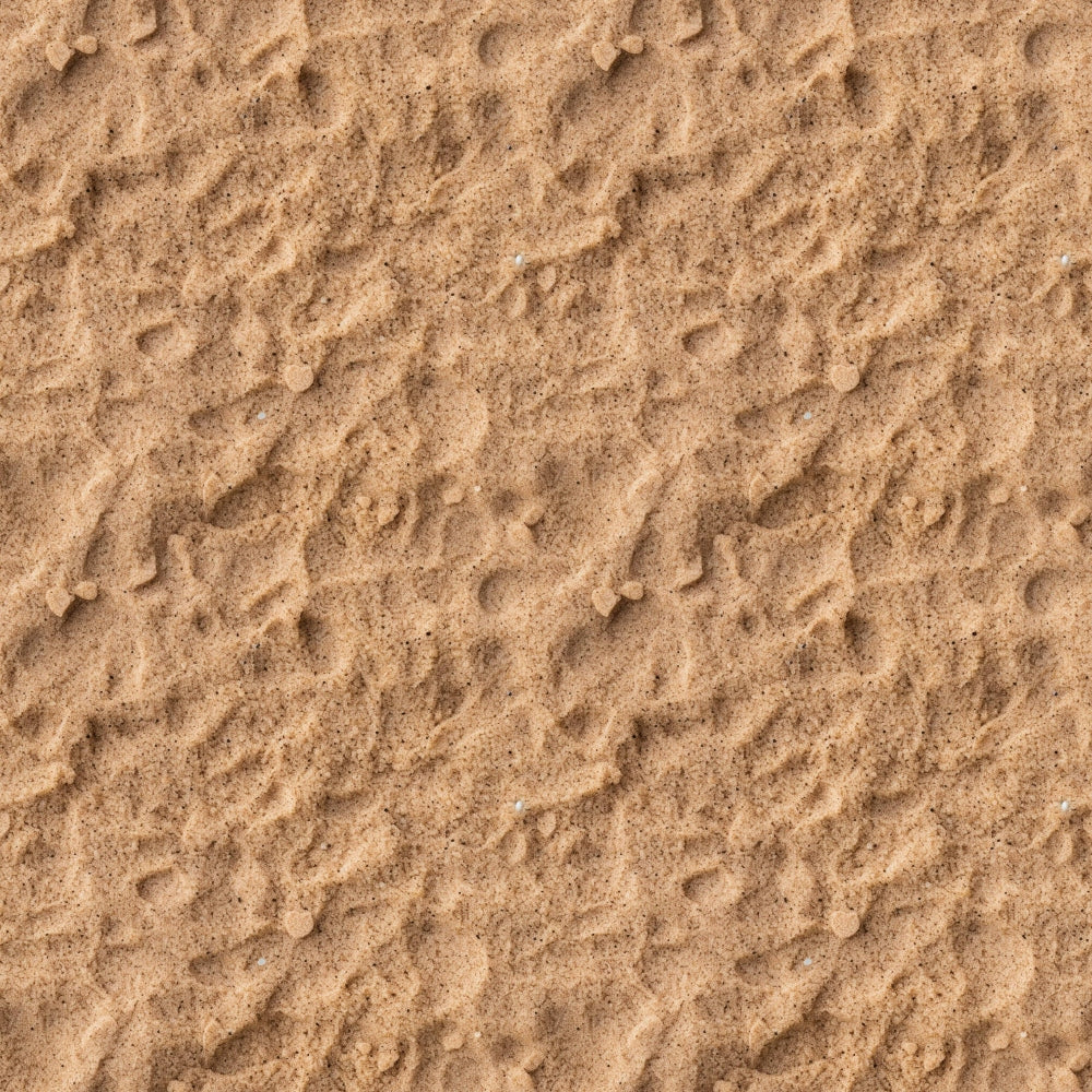 A close-up view of textured sand with small ripples and scattered pebbles.