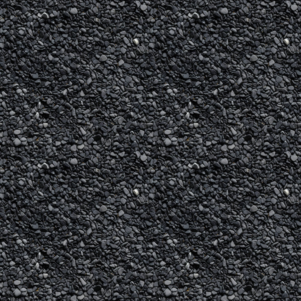 A textured surface of small, uniform dark gray stones closely packed together.