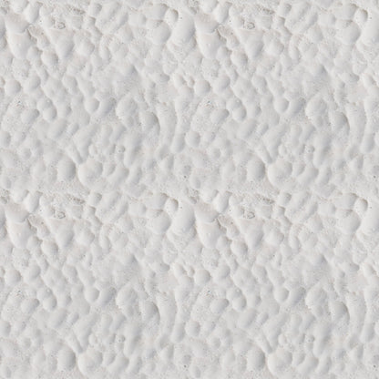 Close-up view of white sand with a pattern of small, uneven ridges and shallow depressions.