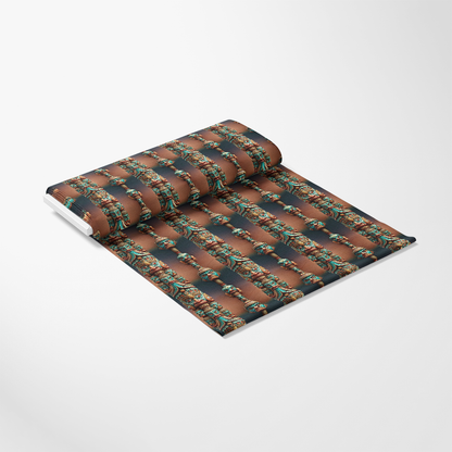 A roll of wallpaper with a repeating ornate, colorful pattern in teal, gold, and red on a brown background, partially unrolled on a white surface.