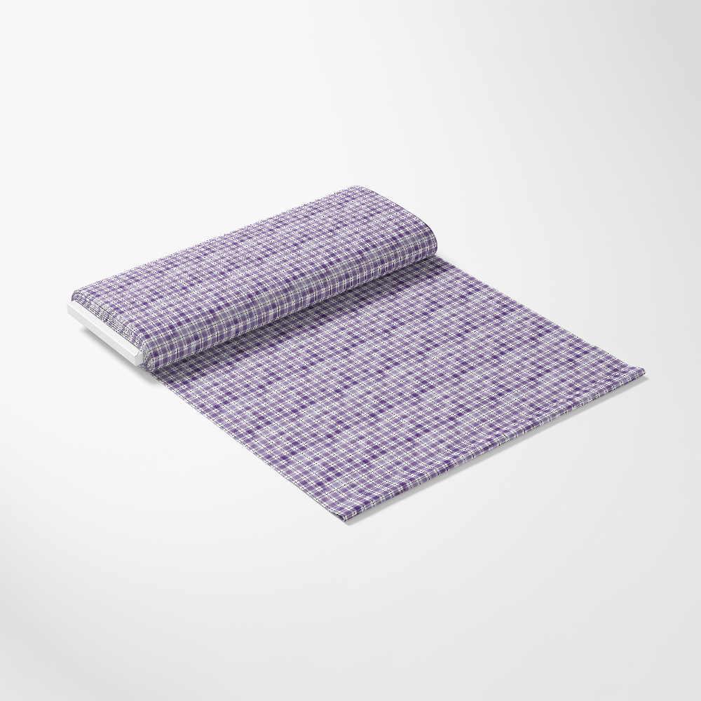A roll of fabric with a purple and white checkered pattern, partially unrolled on a white surface.