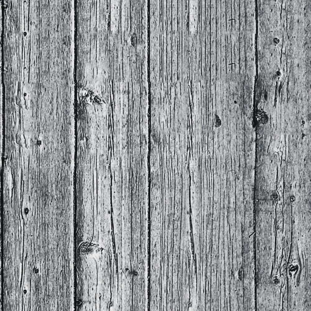 Close-up of a weathered wooden surface with vertical planks. The texture shows visible grain, knots, and signs of aging. The wood appears grayish in tone.