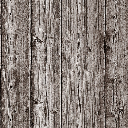 Close-up of a weathered wooden surface with vertical planks showing natural knots and grain textures in shades of brown and gray.